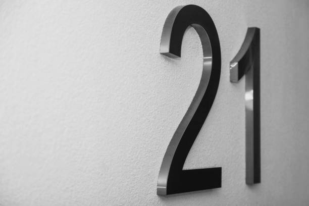 istock Number twenty one on texture light wall, symbolizing year 2021 1294134898