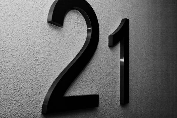 istock Number twenty one on texture light wall, symbolizing year 2021 1294134902