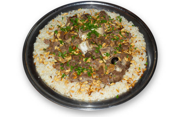 istock camel meat with rice traditional Arab food main course restaurant lunch served with almonds and pine seeds. 1294137062