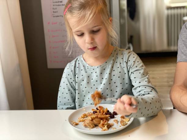 istock Little girtl is Eating Applepie 1294140035