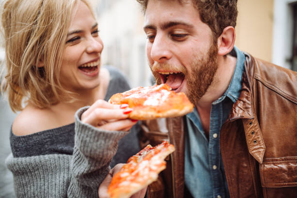 friends eating pizza in italy