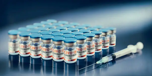 Group of Covid-19 vaccine in small bottles with syringe