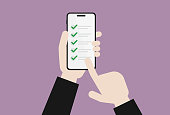 istock Businessman holds a mobile phone for a checklist 1294144691