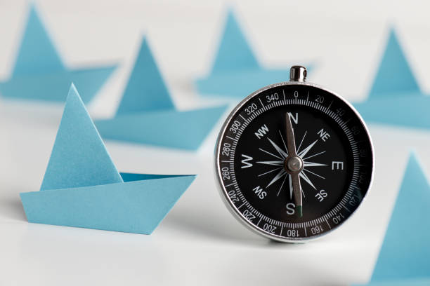 istock Blue Paper Boats With Compass 1294145249