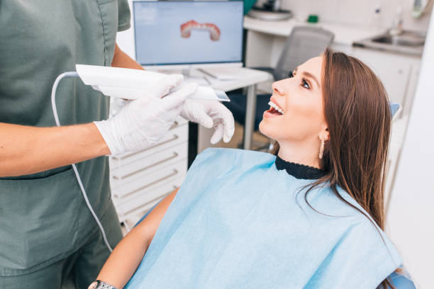 The dentist scans the patient's teeth with a 3d scanner. The dentist scans the patient's teeth with a 3d scanner. 3d scanning photos stock pictures, royalty-free photos & images