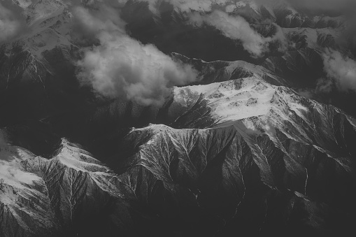 Tien Shan Mountains in northwestern China from the air in black and white.