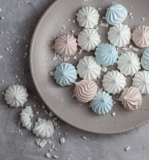 istock Multicolored meringues on a concrete background. 1294145693