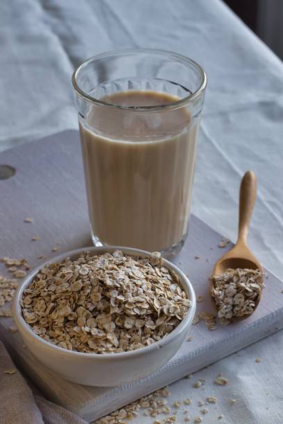 istock Oat milk and oatmeal on a light background. 1294145723