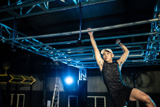 istock Asian Chinese man athlete competing in an obstacle course. 1294146889