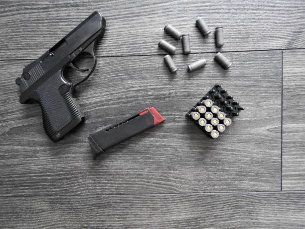 istock Small self-loading pistol-PSM 5.45 * 18 mm, with cartridges on a dark background 1294147927