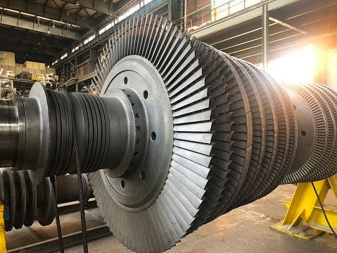 Turbine generator rotor with blades and discs, interior view. Elements, details and mechanisms of turbines. Energy and mechanical engineering