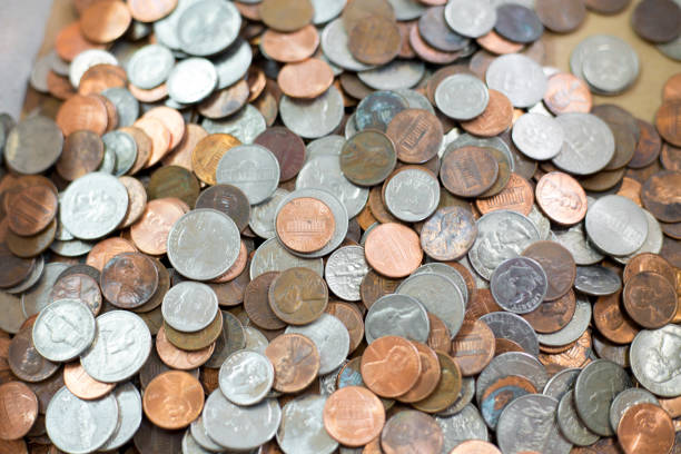 istock US Coins scattered on old wooden table. 1294148313