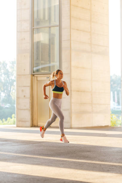 istock Woman running in urban environment 1294149141
