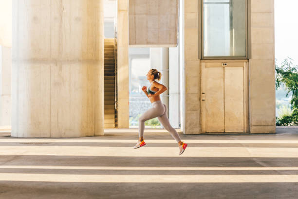 istock Woman running in urban environment 1294149183
