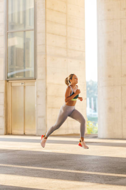 istock Woman running in urban environment 1294149336