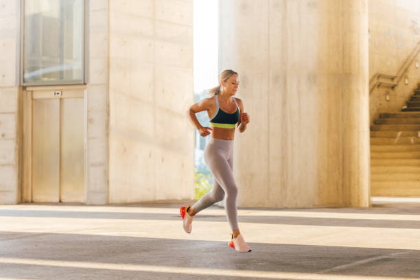 istock Woman running in urban environment 1294149402