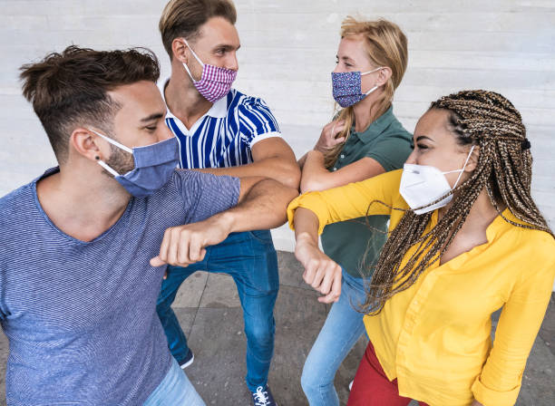 istock Young multiracial people meet and greet each other with elbow while wearing protective face masks - Prevention for coronavirus and alternative lifestyle 1294155591