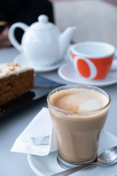 istock Cup of coffee, carrot cake and tea at a restaurant table 1294159898
