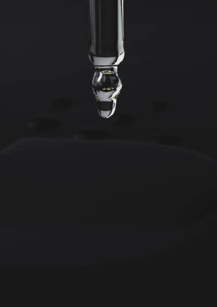 istock Oil dripping from a pipette on a black background 1294161053