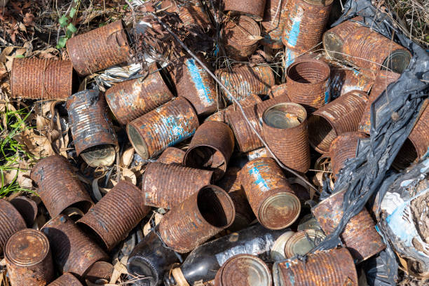 istock Old rusty cans lie on the ground and dry grass in nature. 1294161276