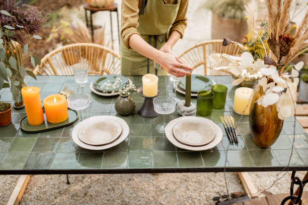 istock Female decorating dinning table in natural style outdoors 1294162011