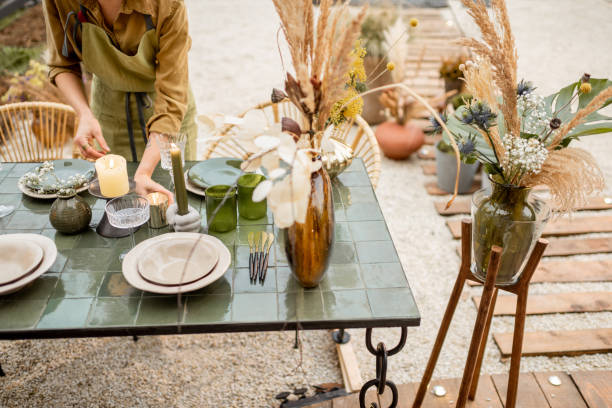 istock Female decorating dinning table in natural style outdoors 1294162022