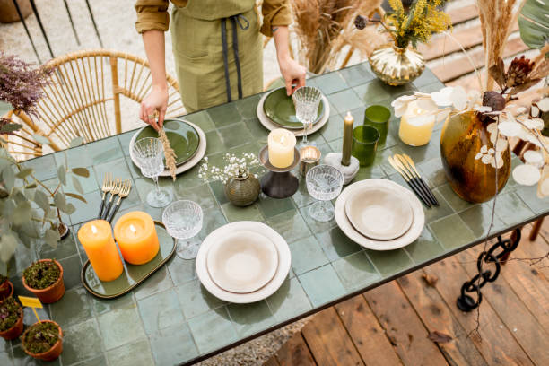 istock Female decorating dinning table in natural style outdoors 1294162035