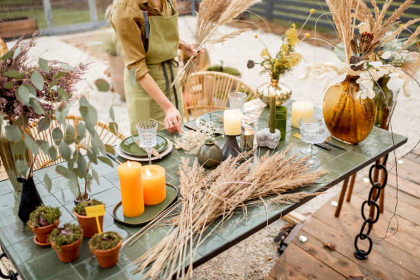 istock Female decorating dinning table in natural style outdoors 1294162039