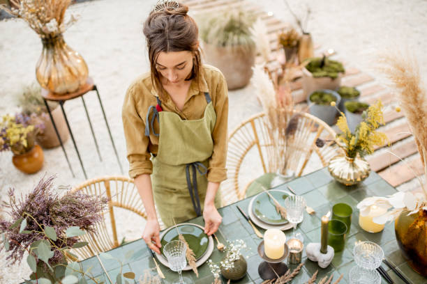 istock Female decorating dinning table in natural style outdoors 1294162046