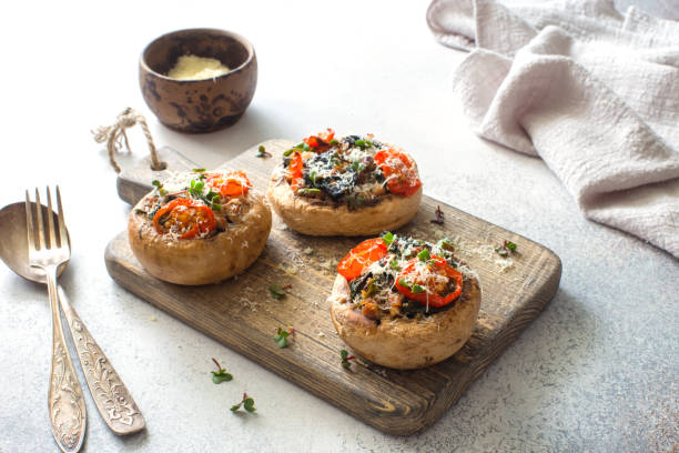 istock Mushrooms stuffed with ground, spinach, tomatoes and parmesan cheese close up 1294163581
