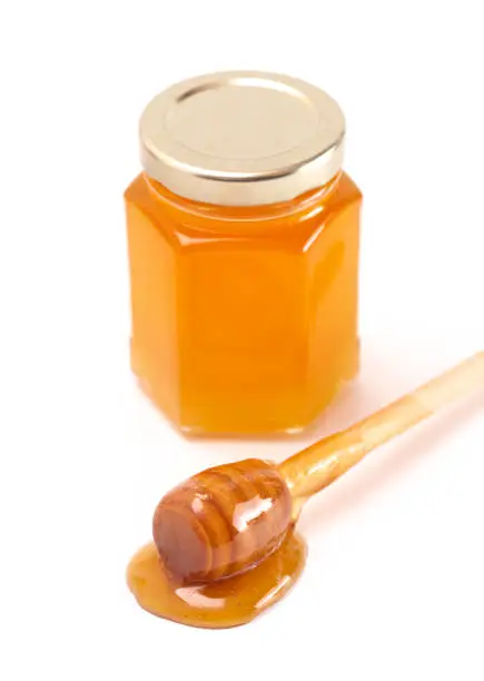 A Jar of Raw Natural Honey Isolated on a White Background