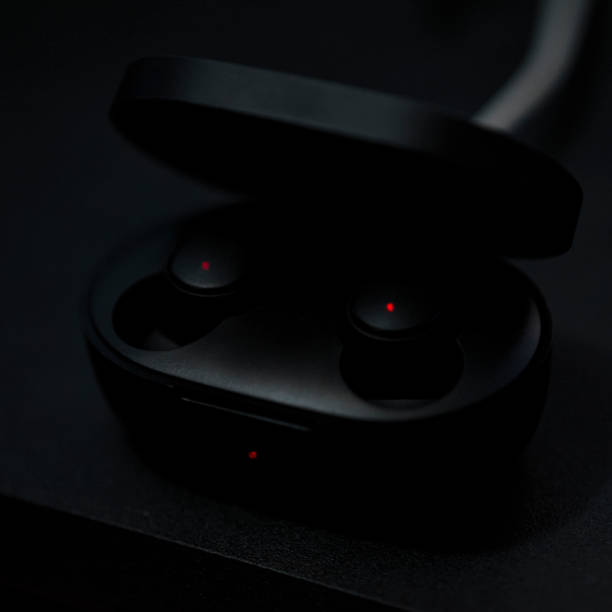 istock Black Bluetooth headphones are charging in the case 1294167081