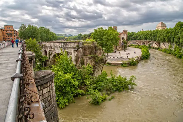 View of the ancient Ponte Rotto or Pons Aemilius with Isola Tiberina in the background, Rome, Italy