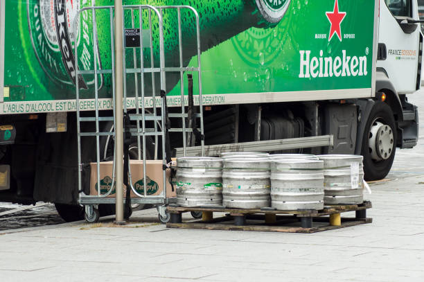 Heineken beer barrels from delivery truck parked in the street near restaurant Mulhouse - France - 3 July 2018 -  Heineken beer barrels from delivery truck parked in the street near restaurant mulhouse photos stock pictures, royalty-free photos & images