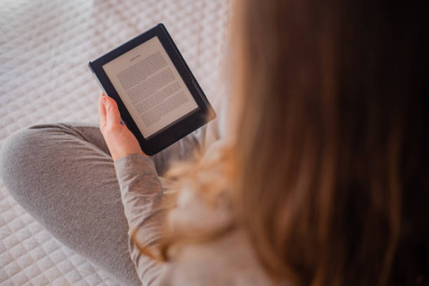 istock Woman reading e-book sitting on bed. Concept for studying, reading 1294173187