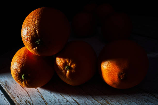 four oranges with light streaks