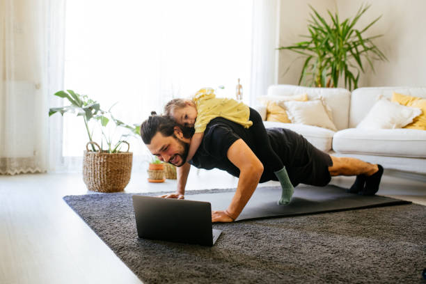 Helping his dad get stronger Young man doing pushups with his daughter on his back push ups stock pictures, royalty-free photos & images