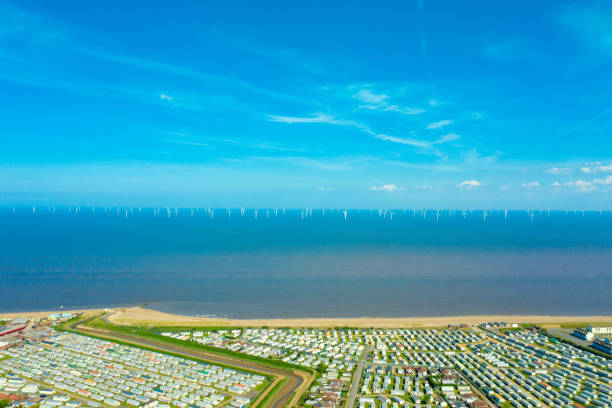 Aerial photo of the Fantasy Island caravan camping resort park in the village of Skegness showing rows of caravans and the amusement park by the ocean and sandy beaches stock photo