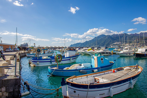 Boats( fishing and pleasure)   in  harbor   of Salerno. South Italy. Sunny day and Amalfo coast at distance!