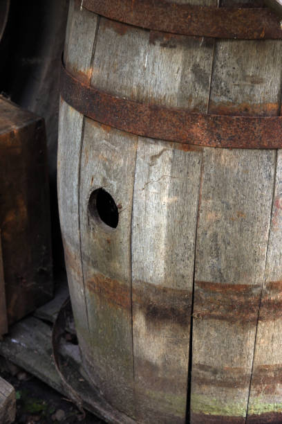istock Old wooden barrel with hole and iron rims 1294179075