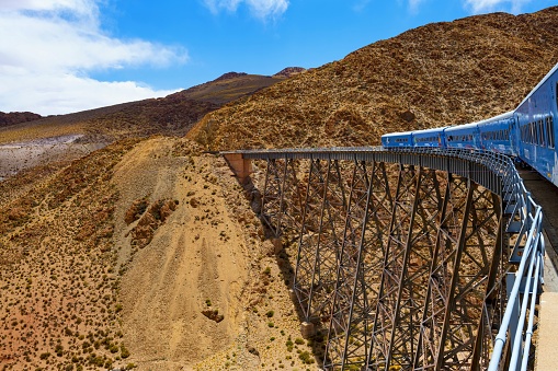 San Antonio de los Cobres, Argentina, November 9, 2019: The so called Train to the clouds (Spanish: Tren a las Nubes) goes through the viaduct La Polvorilla in the Andes at an altitude of 4300 meters. The \