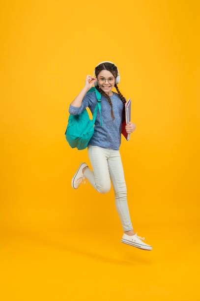 istock Active learning. Active girl run to school. Happy kid back to school. Active childhood. School time. September 1. Childs development and growth. Active and energetic 1294179813