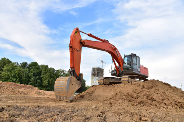 istock Excavator during excavation aond road construction works at construction site on sunset background 1294181660