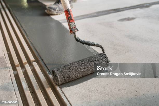 Manual Worker Putting Nonslip Layer On The Floor Stock Photo - Download Image Now - Painting - Activity, Flooring, Concrete