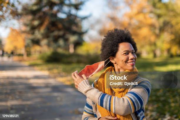 African American Woman Taking Off Face Mask Stock Photo - Download Image Now - Protective Face Mask, Removing, Coronavirus