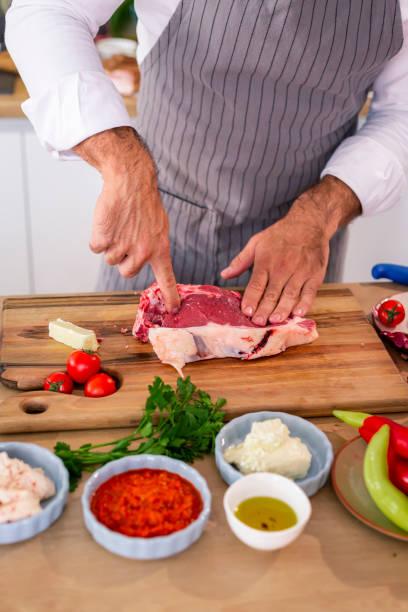 istock The chef examines the meat softness on a wooden kitchen board 1294186097