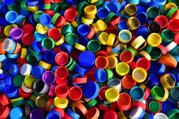 Photo of Plastic bottle caps background. Cap material is recyclable