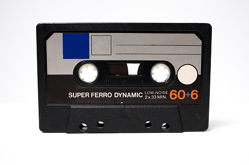 an old vintage audio cassette tape with a white background. Retro 70s 80s style. Audio tape, retro music.