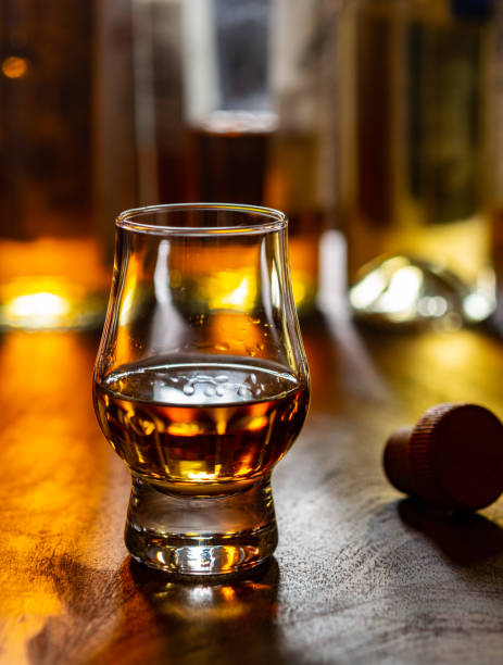 istock Dram of single malt scotch whisky and bottles on background 1294193318