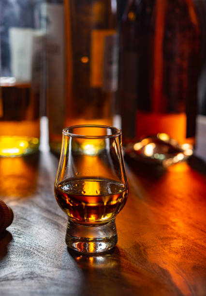istock Dram of single malt scotch whisky and bottles on background 1294193319